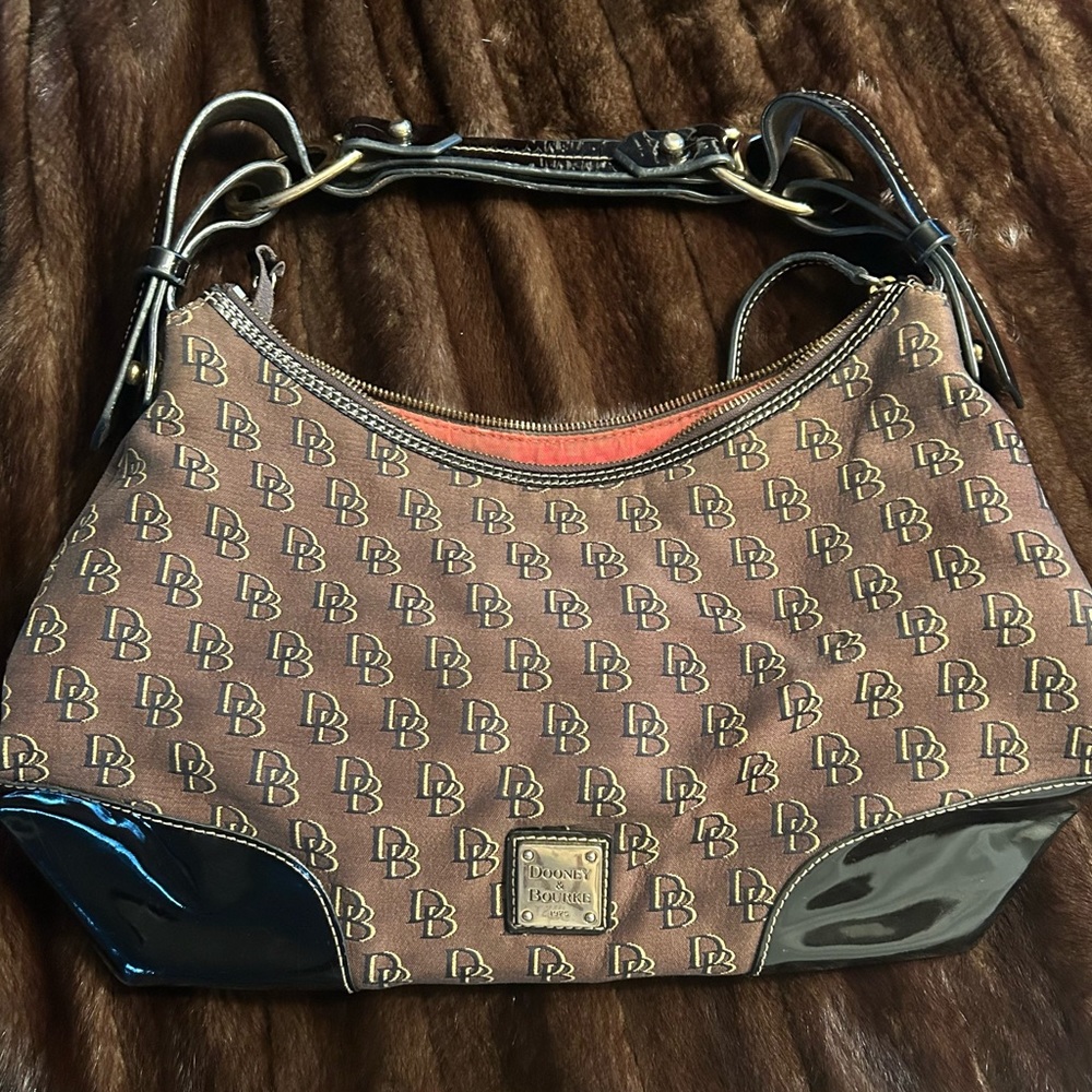 Dooney and Bourke Nikki Shadow Signature Canvas and Patent shoulder bag.
